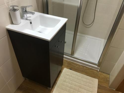 a bathroom with a sink and a shower at Casa Dos Cabecinhos in Paradamonte