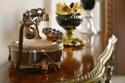 a wooden table with a telephone on top of it at Indana Palace, Jodhpur in Jodhpur