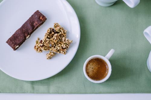 a plate of cookies and a cup of coffee at Pangea e Panthálassa B&B in Lecce