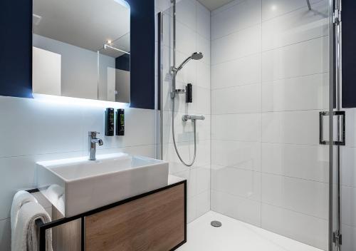 a bathroom with a sink and a shower at Hotel Wittorf in Neumünster