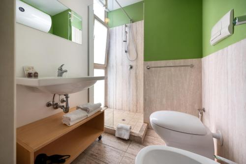 a bathroom with a toilet and a sink and a shower at Vitorno Residence in San Vito lo Capo