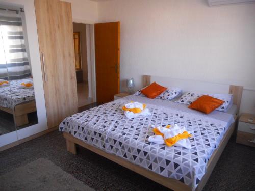 een slaapkamer met een bed met oranje en witte lakens bij Amalia Belvedere in Rijeka
