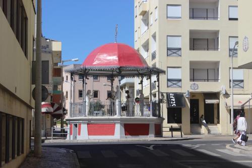 a red and white food truck parked on the side of a street at Eurosun Hotels Loulé in Loulé