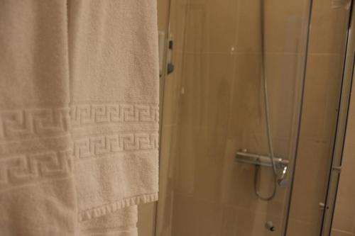 a bathroom with a shower with a shower curtain at Eurosun Hotels Loul&eacute; in Loul&eacute;