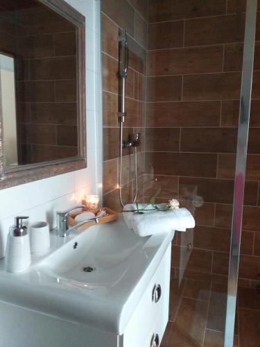 a bathroom with a sink and a shower at Monato in Poprad