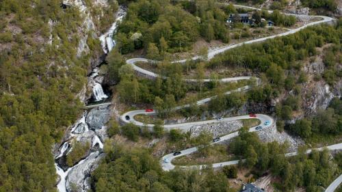 an aerial view of a winding road in a forest at Lærdalsøren Motor Guesthouse in Lærdalsøyri
