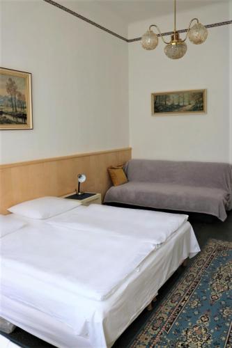 a bedroom with two beds and a rug at Pension Reimer in Vienna