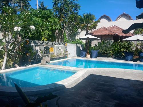 a swimming pool in front of a house at ZiFa Mandalika in Kuta Lombok