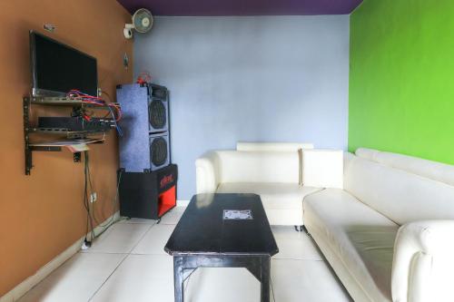 a living room with a couch and a table at Villa Ana in Pasuruan