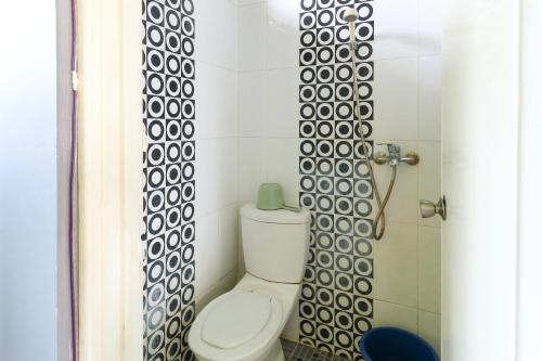a bathroom with a toilet and a shower at Villa Ana in Pasuruan
