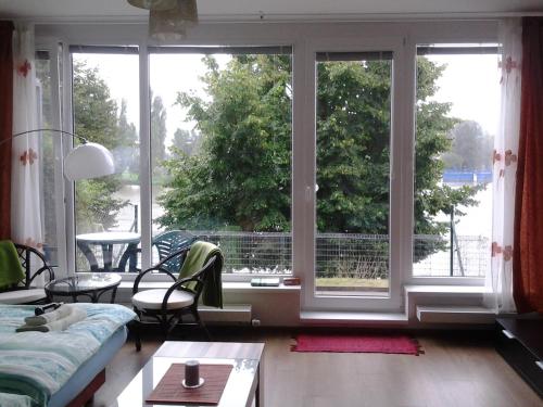 a living room with a large window with a view at Apartmán Residence Nábřeží in Beroun
