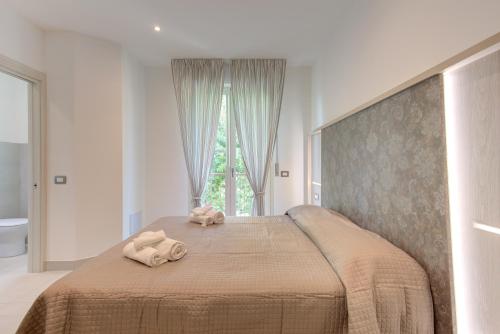a bedroom with a bed with two towels on it at Alloggio Nella in Rimini