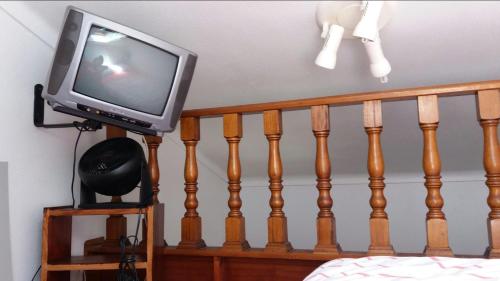 a tv sitting on top of a wooden rail at Country House Alfarim in Alfarim