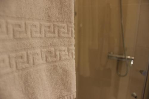 a shower stall with a towel hanging on the wall at Eurosun Hotels Loulé in Loulé