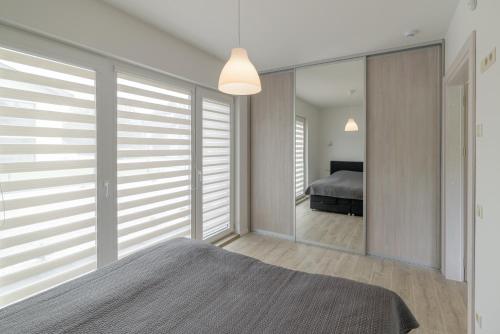 Postel nebo postele na pokoji v ubytování Gerves Apartamentai