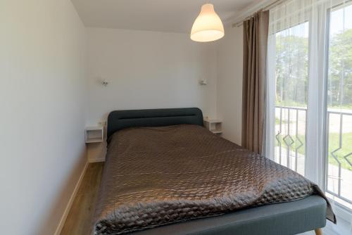 Postel nebo postele na pokoji v ubytování Gerves Apartamentai