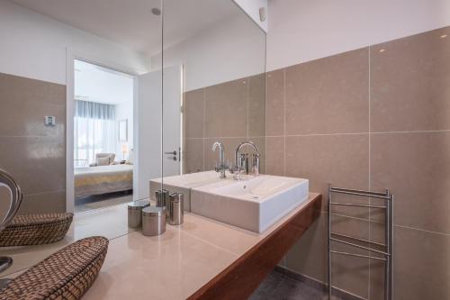 a bathroom with a white sink and a mirror at Bela Vista da Luz 17 by Destination Algarve in Luz