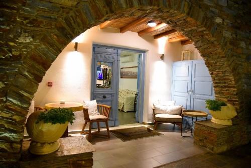 an archway in a room with a table and chairs at Hotel Messaria in Kithnos