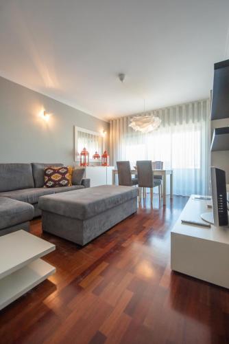 a living room with a couch and a table at Apartamento Mouzinho de Albuquerque in Matosinhos