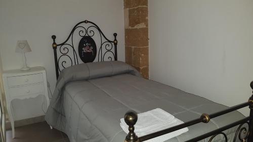 a bedroom with a bed and a table with a night stand at Borgo Sofia Bed and Breakfast in Mesagne