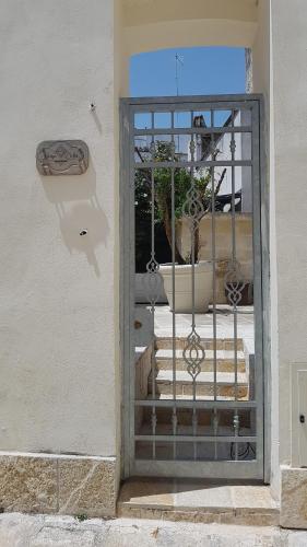 a gate with a potted plant on a balcony at Borgo Sofia Bed and Breakfast in Mesagne