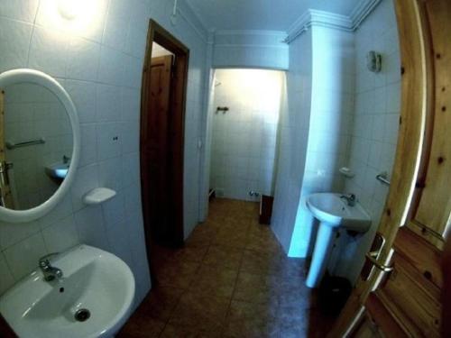 a bathroom with a sink and a mirror at Alojamiento covadonga in La Riera
