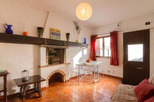 a living room with a table and a fireplace at Casa T'Isabel - Fisherman's Beach - 2 bedrooms in Albufeira
