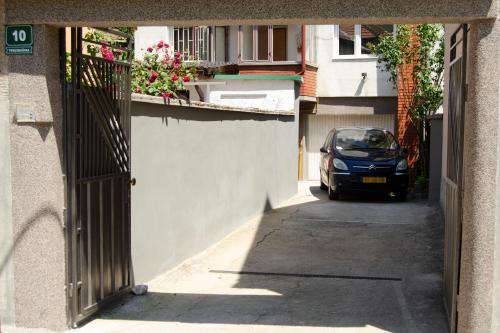 an alley with a car parked in a building at Apartmani Balibeg in Sarajevo