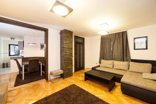 a living room with a couch and a table at Apartments Neivado in Zlatibor
