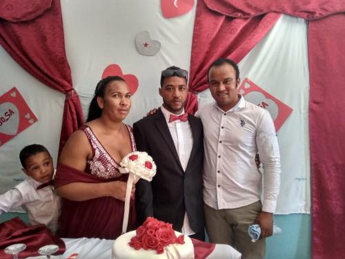 a group of people standing in front of a cake at Ciza e Rose in Portela