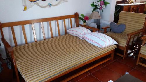 a bed with two pillows on it in a room at Country House Alfarim in Alfarim