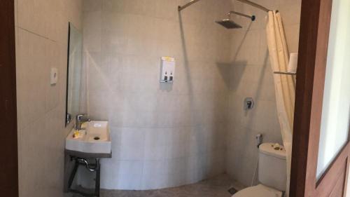 a bathroom with a sink and a toilet and a shower at Oka's Guest House Canggu in Canggu