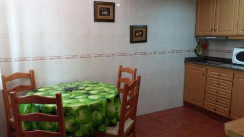 a kitchen with a table with green apples on it at Country House Alfarim in Alfarim