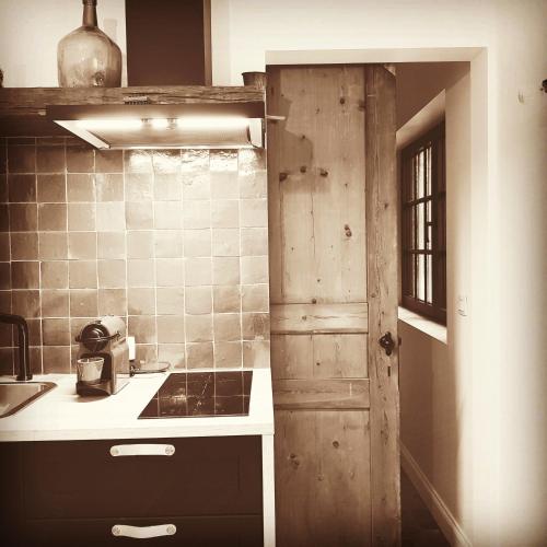a kitchen with a sink and a counter top at Vakantiehuis ABEL in Dilsen-Stokkem