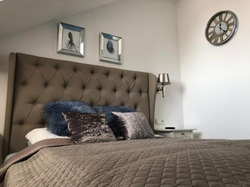 a bedroom with a large bed with blue pillows at Moon River Apartments Gdansk Old Town in Gdańsk