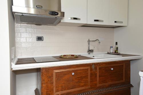 a kitchen with a sink and a counter top at Casa Martelli in Belgirate