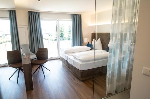 a hotel room with a bed and a glass wall at Hotel Weiß in Munderfing