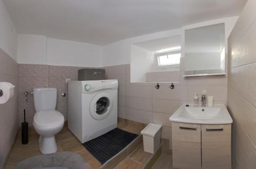 a bathroom with a washing machine and a sink at Spartion Marine in Split