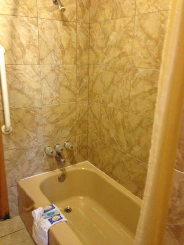 a bathroom with a bath tub in a bathroom at DeQueen Courtyard Inn in De Queen