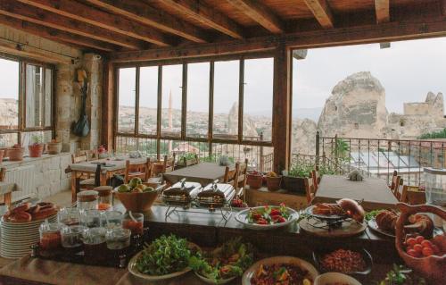 a room with a table full of food with a view at Panoramic Cave Hotel in Goreme