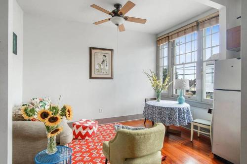a living room with a ceiling fan and a table at Freret Apartments near Streetcar & Tulane in New Orleans