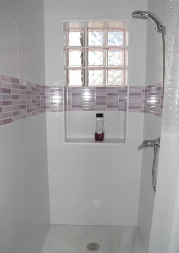 a bathroom with a shower and a window in it at Be happy Arco in Algodonales