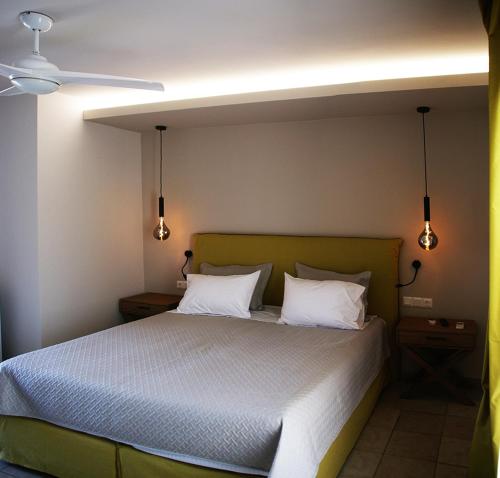 a bedroom with a bed with two white pillows at Thalero Holidays Center in Lygia