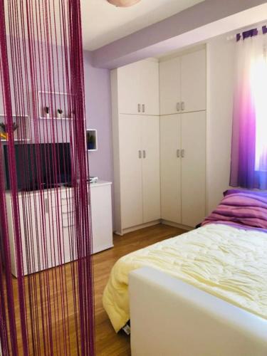 a bedroom with a bed and white cabinets at Apartman Nekic in Cres