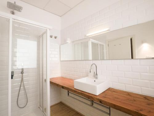 a white bathroom with a sink and a shower at Orient Capdepera - Turismo de Interior in Capdepera