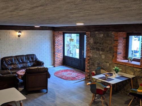 a living room with a couch and a table at Hotel Terrace Rabath in Akhaltsikhe