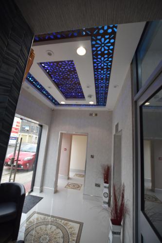 a room with a ceiling with blue lights on it at PremierLux Serviced Apartments in Ilford