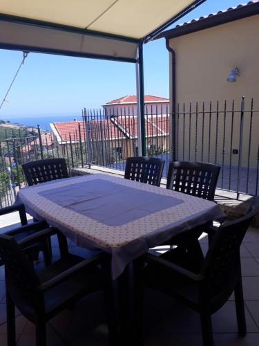 a table and chairs on a balcony with a view at Barbara's House - Liguria in Santo Stefano al Mare