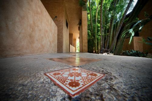 a red and white tile on the floor of a building at Hotel Barrio Latino in Playa del Carmen