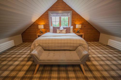 a bedroom with a bed and a bench in a attic at High Oaks Grange - Lodges in Pickering